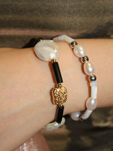 wearing black onyx beaded bracelet and pinctada beaded bracelet